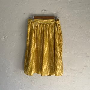 Yellow polka dot skirt with pockets.